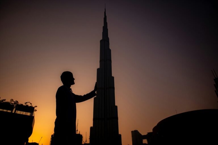 man standing near Burj Khalifa during sunset