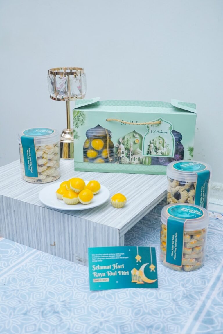 a table topped with a plate of oranges next to a box of cookies